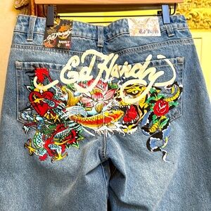 New Ed Hardy Baggy blue Jeans. Sz 30. Ed Hardy collage of pictures on rear.